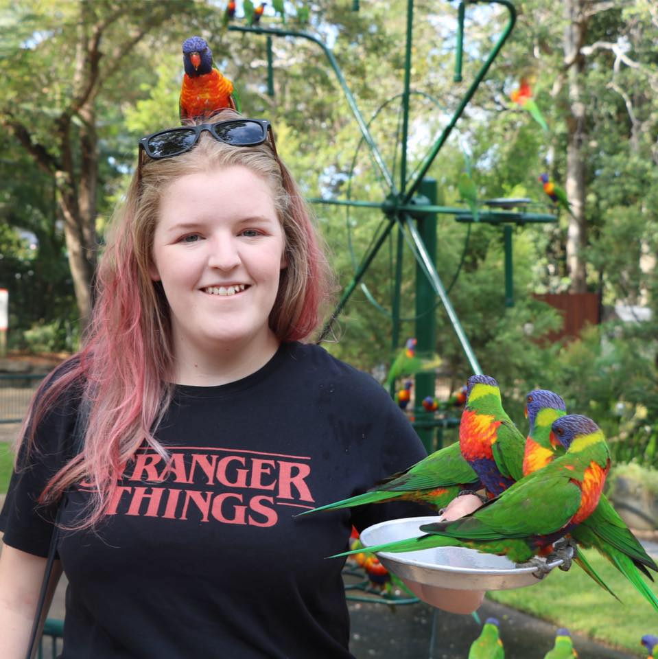 Madi McGuire with rainbow lorikeets