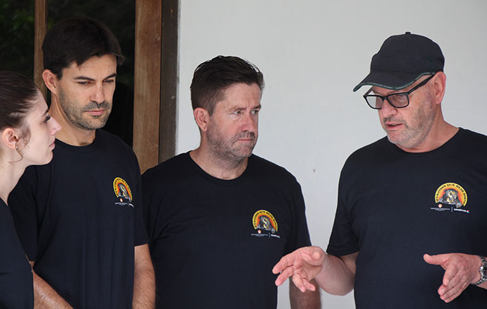 Dr Larry Vogelnest (at right) discusses procedure with other vets in Borneo.